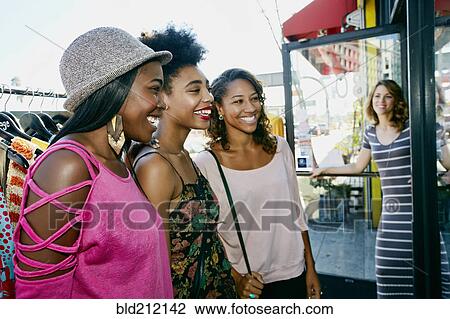 Stock Image - Women shopping on city street. Fotosearch