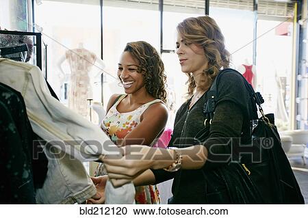 Women shopping together in store View Large Photo Image Stock Image - Women shopping together in store. Fotosearch