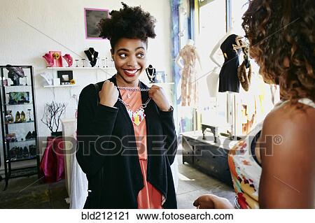 Stock Image - Women shopping together in store. Fotosearch