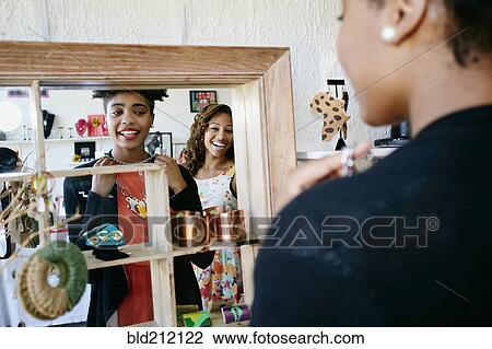Stock Image - Women shopping together in store. Fotosearch