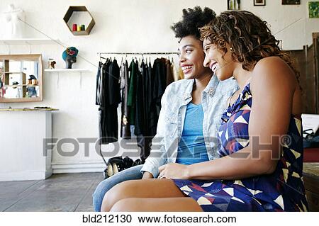 Stock Image - Women shopping together in store. Fotosearch