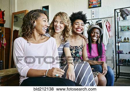 Women sitting together in store View Large Photo Image Stock Photo - Women sitting together in store. Fotosearch