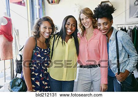 Women smiling together in store View Large Photo Image Stock Image - Women smiling together in store. Fotosearch