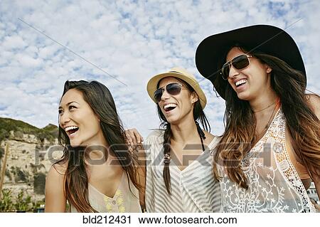 Women smiling together on beach View Large Photo Image Stock Image - Women smiling together on beach. Fotosearch
