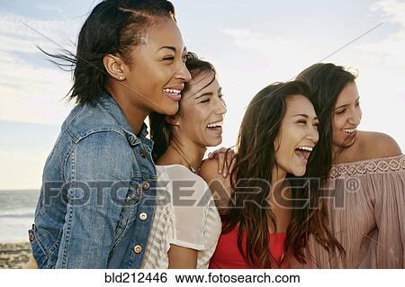Women smiling together on beach View Large Photo Image Stock Photograph - Women smiling together on beach. Fotosearch