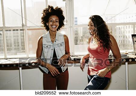 Stock Image - Women smiling together. Fotosearch