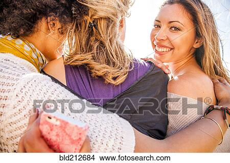 Picture - Women standing together outdoors. Fotosearch