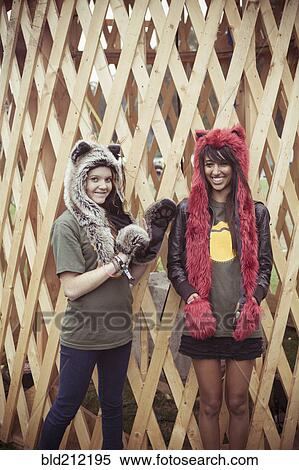 Stock Photography - Women wearing furry hats outdoors. Fotosearch