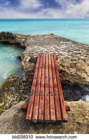 Wooden bridge across rocks on the coastline View Large Photo Image Stock Image - Wooden bridge across rocks on the coastline. Fotosearch