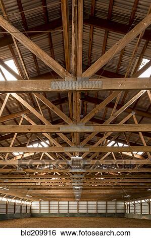 Wooden rafters in indoor horse riding ring View Large Photo Image Stock Photograph - Wooden rafters in indoor horse riding ring. Fotosearch