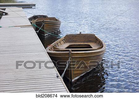 Wooden rowing boats moored View Large Photo Image Picture - Wooden rowing boats moored. Fotosearch