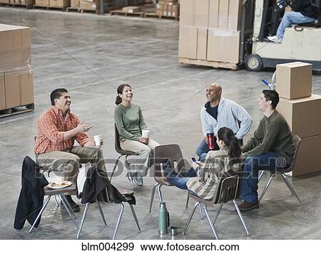 Workers enjoying coffee break in warehouse View Large Photo Image Stock Photo - Workers enjoying coffee break in warehouse. Fotosearch