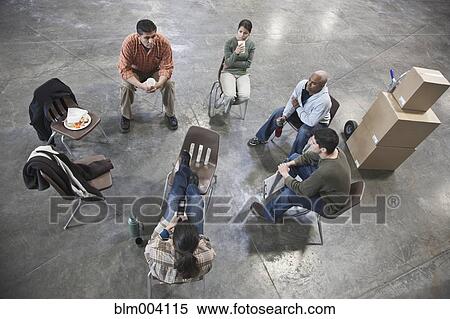 Workers enjoying coffee break in warehouse View Large Photo Image Stock Photography - Workers enjoying coffee break in warehouse. Fotosearch