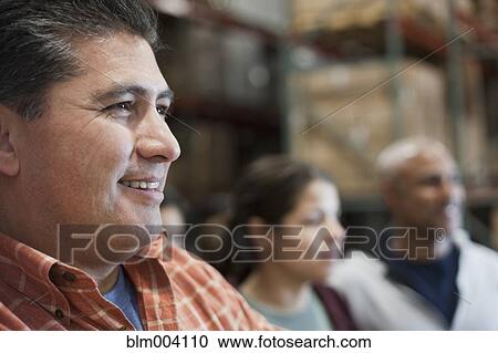 Stock Image - Workers in warehouse. Fotosearch