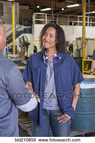 Workers shaking hands in warehouse View Large Photo Image Stock Photo - Workers shaking hands in warehouse. Fotosearch