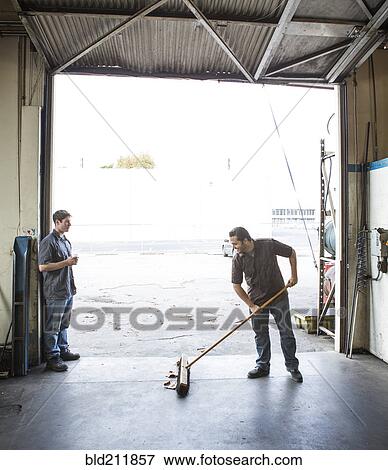 Workers talking at warehouse loading dock View Large Photo Image Stock Photo - Workers talking at warehouse loading dock. Fotosearch