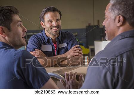 Workers talking in warehouse View Large Photo Image Stock Image - Workers talking in warehouse. Fotosearch