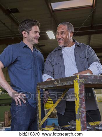 Workers talking in warehouse View Large Photo Image Stock Image - Workers talking in warehouse. Fotosearch
