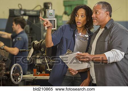 Workers talking in warehouse View Large Photo Image Stock Photography - Workers talking in warehouse. Fotosearch