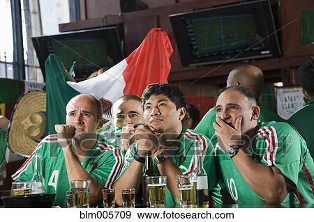 Worried men watching television in sports bar View Large Photo Image Stock Photo - Worried men watching television in sports bar. Fotosearch