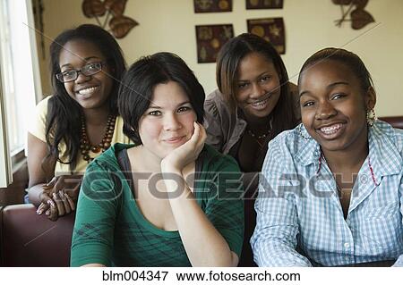 Young women smiling in diner View Large Photo Image Stock Photo - Young women smiling in diner. Fotosearch