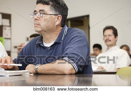Adult students listening in classroom View Large Photo Image Stock Image - Adult students listening in classroom. Fotosearch