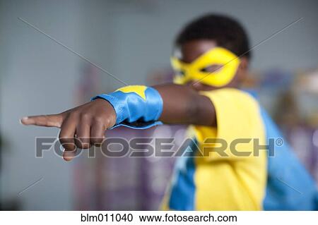 Stock Image - African American boy playing in superhero costume. Fotosearch