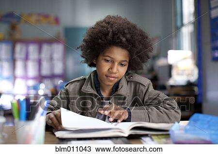 Stock Image - African American boy studying in classroom. Fotosearch