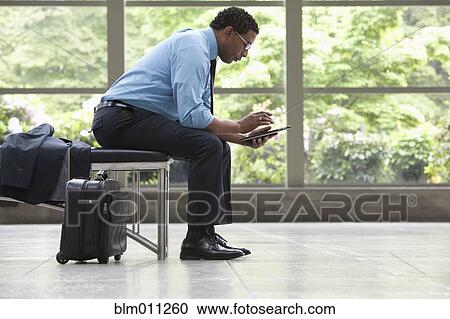 African American businessman using digital tablet in lobby View Large Photo Image Stock Image - African American businessman using digital tablet in lobby. Fotosearch