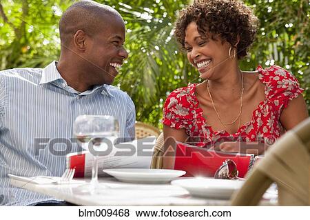 Stock Photo - African American couple eating in restaurant. Fotosearch