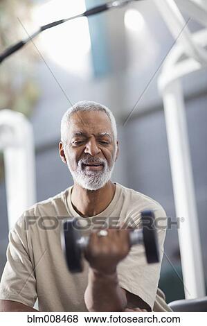 Stock Photo - African American man exercising in health club. Fotosearch