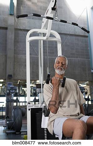 Stock Photo - African American man exercising in health club. Fotosearch