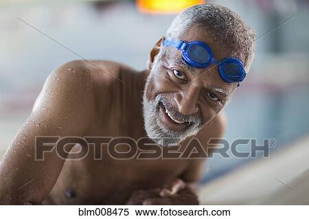 Stock Photography - African American man in swimming pool. Fotosearch