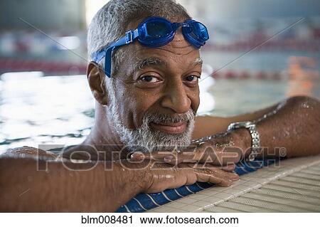 African American man leaning on edge of swimming pool View Large Photo Image Stock Image - African American man leaning on edge of swimming pool. Fotosearch