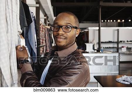 African American man shopping in clothing store View Large Photo Image Stock Image - African American man shopping in clothing store. Fotosearch