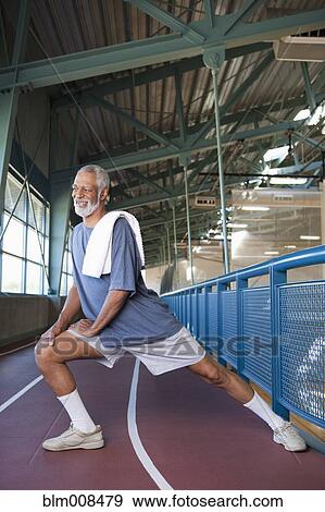 African American man stretching in health club View Large Photo Image Stock Photo - African American man stretching in health club. Fotosearch