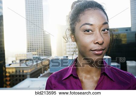African American woman smiling on urban rooftop View Large Photo Image Stock Photography - African American woman smiling on urban rooftop. Fotosearch