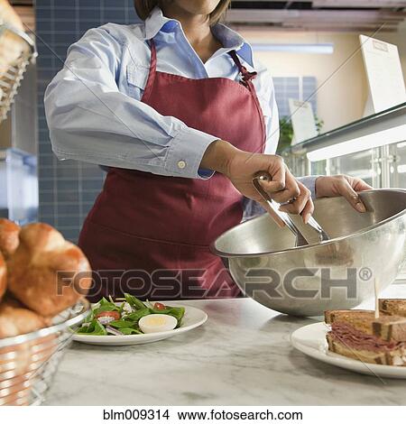 African American worker mixing salad in cafe View Large Photo Image Picture - African American worker mixing salad in cafe. Fotosearch