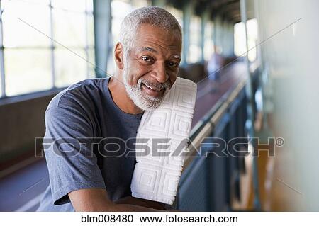 Stock Image - African man standing in health club. Fotosearch