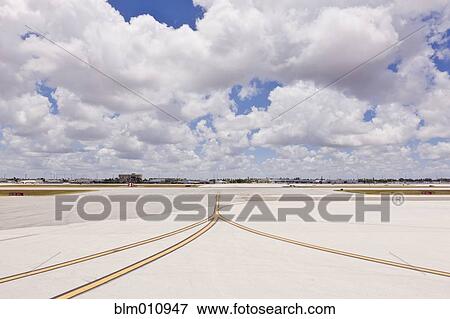 Stock Photo - Airport tarmac and cloudy sky. Fotosearch