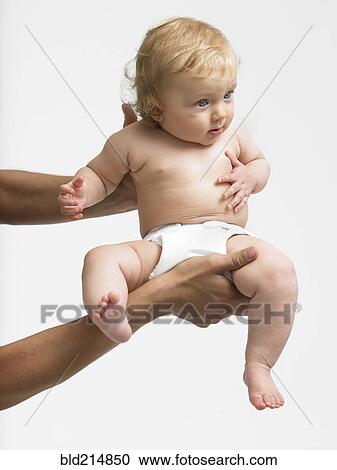 Stock Image - Arms of mixed race father holding baby girl. Fotosearch