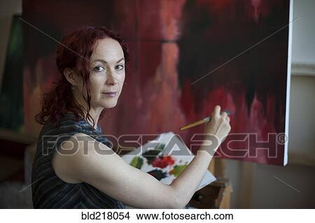 Artist painting on canvas in studio View Large Photo Image Picture - Artist painting on canvas in studio. Fotosearch