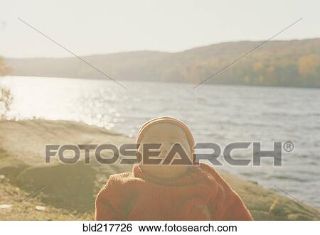 Stock Photograph - Asian baby girl at remote lake. Fotosearch