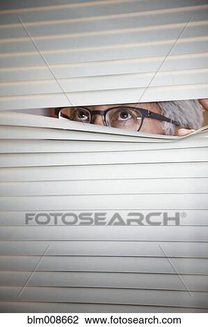 Asian businessman peering through office blinds View Large Photo Image Stock Image - Asian businessman peering through office blinds. Fotosearch