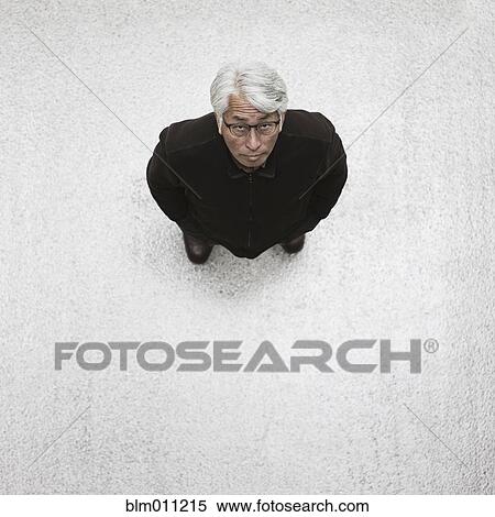 Stock Photography - Asian businessman standing in lobby. Fotosearch