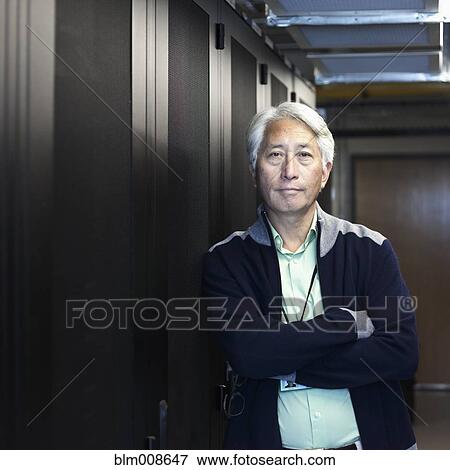 Asian businessman working in office technology room View Large Photo Image Stock Photo - Asian businessman working in office technology room. Fotosearch