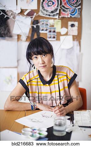 Asian designer painting in studio View Large Photo Image Stock Image - Asian designer painting in studio. Fotosearch
