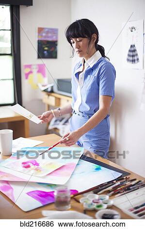 Asian designer painting in studio View Large Photo Image Stock Photograph - Asian designer painting in studio. Fotosearch