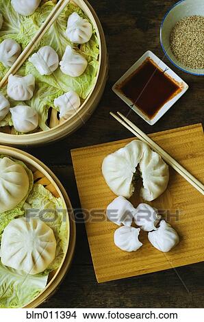 Picture - Asian dumpling in steamer with cabbage. Fotosearch
