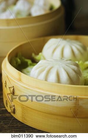 Stock Image - Asian dumpling in steamer with cabbage. Fotosearch